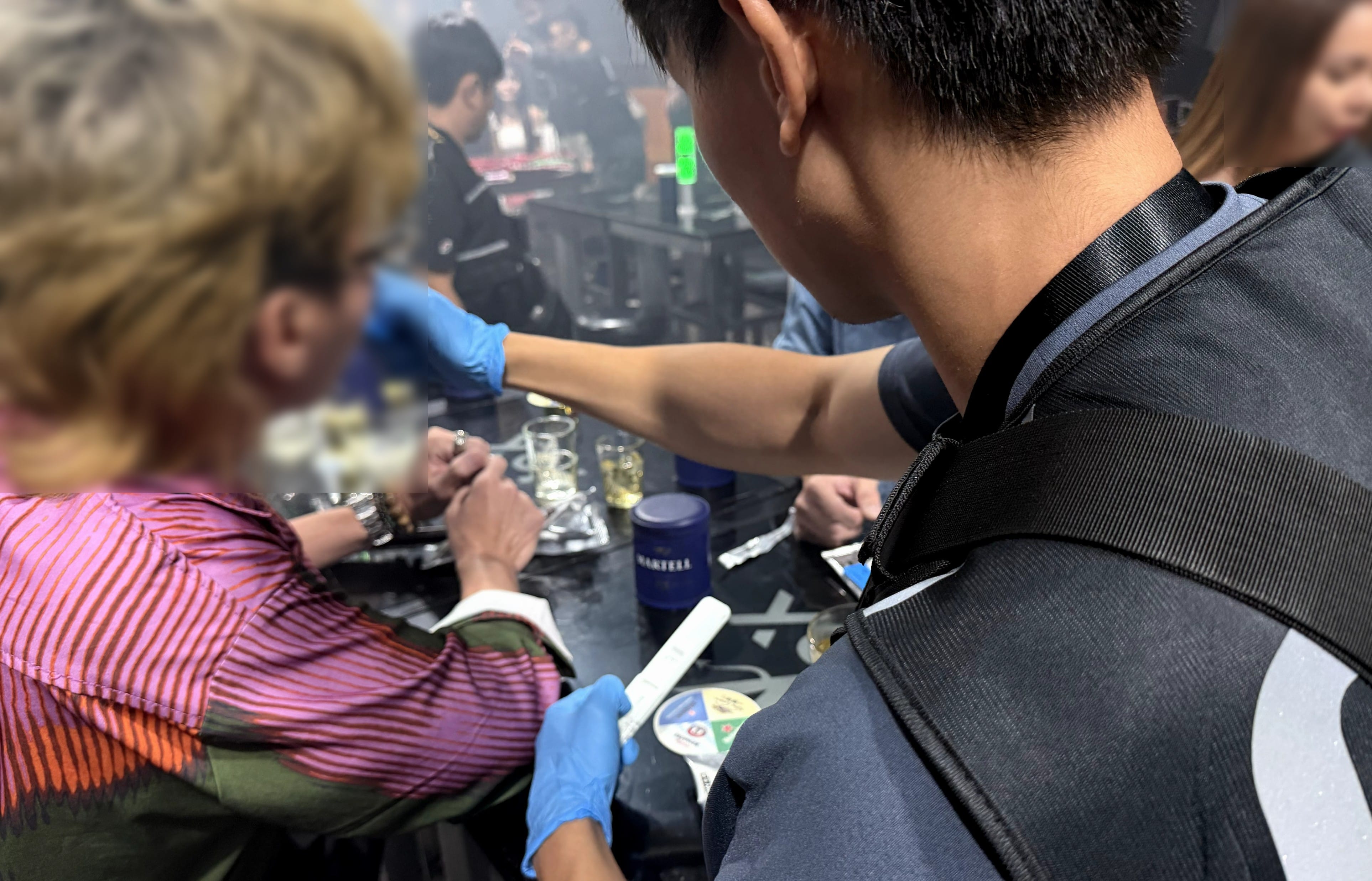 Photos 1 and 2 (CNB): CNB officers conducting saliva tests at a nightlife establishment during a joint enforcement operation on 8 October 2026.